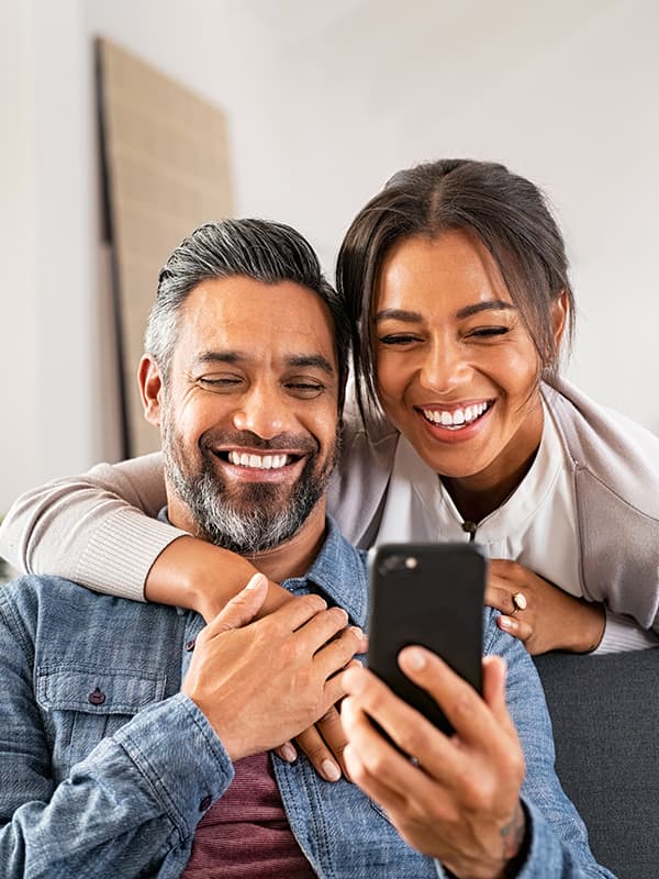 A couple looking at their mobile phone